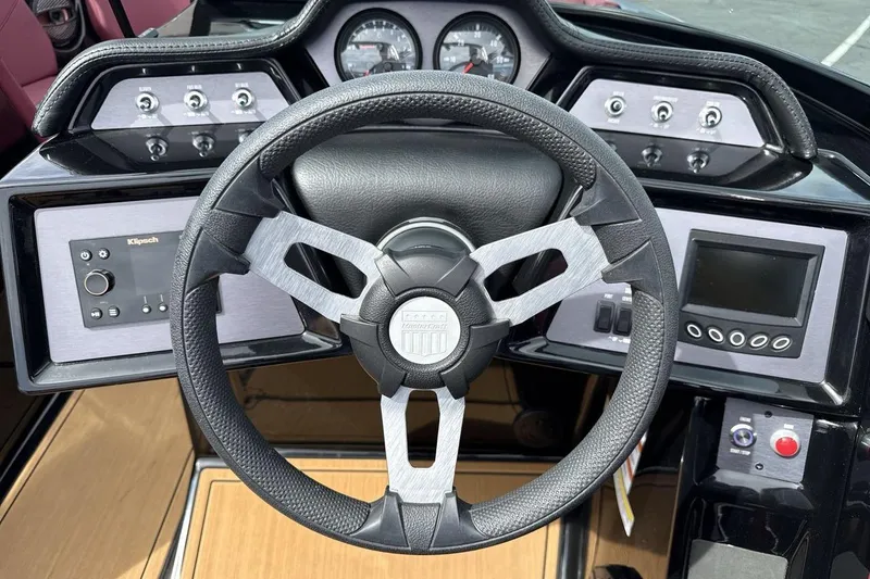Slide: The Image of 2023 MasterCraft NXT22 dashboard with steering wheel, gauges, and control panels. - 14