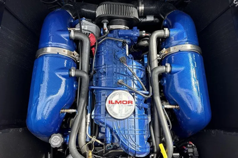 Slide: The Image of 2023 MasterCraft NXT22 Ilmor engine, featuring blue components and intricate piping. - 20