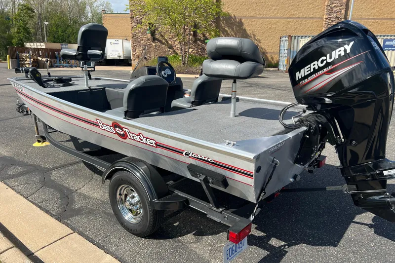 Slide: The Image of 2019 Tracker Bass Tracker Classic XL boat with Mercury engine, parked outdoors. - 5