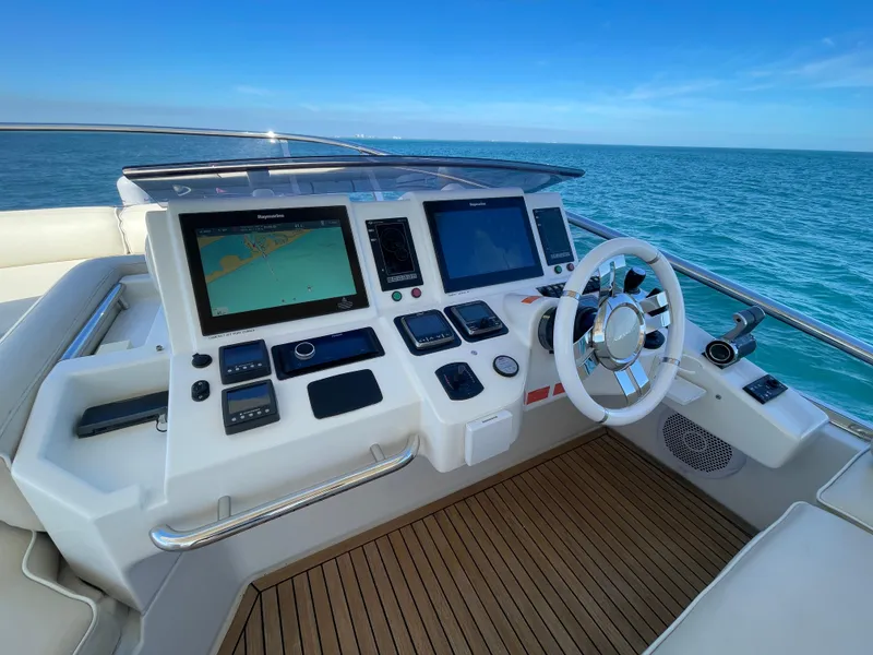Slide: The Image of 2014 Azimut 70 yacht helm with navigation screens and steering wheel, overlooking the ocean. - 27