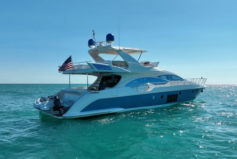 Slide: The Image of 2014 Azimut 70 yacht on open water, featuring sleek design and American flag. - 5