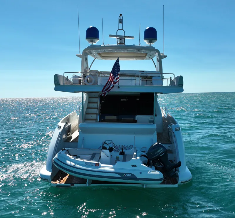 Slide: The Image of Azimut 70 yacht from 2014 on open water, featuring a small boat on the deck. - 7