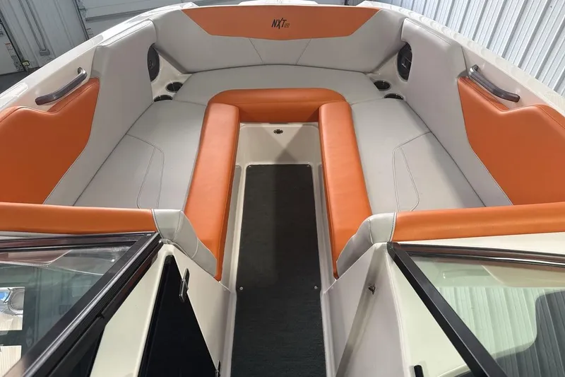 Slide: The Image of 2021 MasterCraft NXT24 boat interior with orange and white seating. - 11