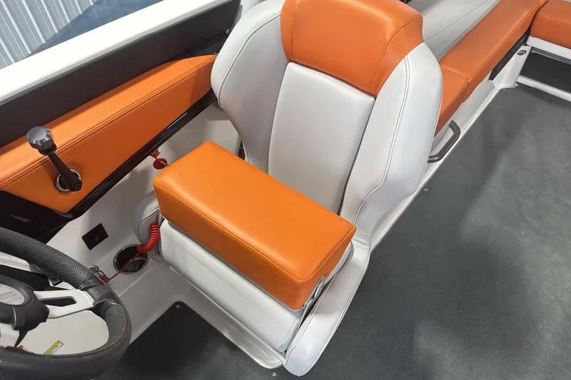 Slide: The Image of 2021 MasterCraft NXT24 boat interior with orange and white seating. - 13