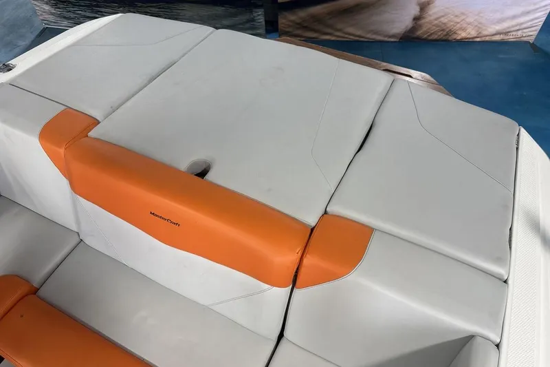 Slide: The Image of 2021 MasterCraft NXT24 boat seating with orange and white upholstery. - 19