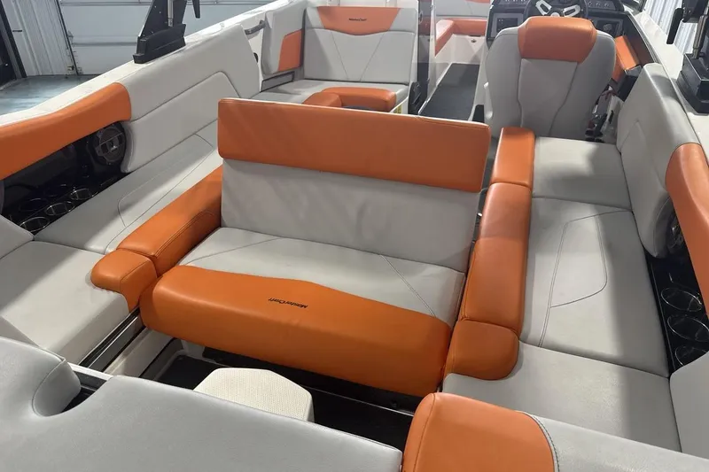 Slide: The Image of 2021 MasterCraft NXT24 boat interior with orange and gray seating. - 23