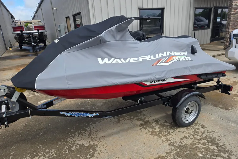 Slide: The Image of 2019 Yamaha WaveRunner VXR covered on trailer, parked outside a building. - 10