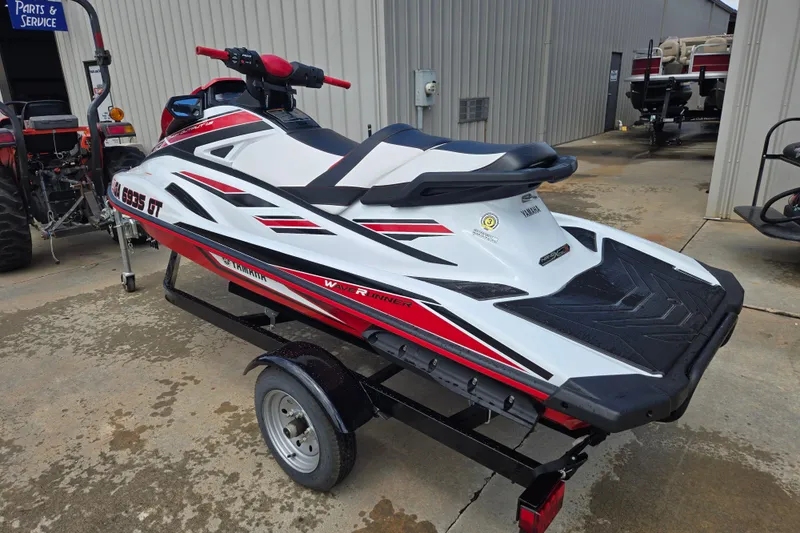 Slide: The Image of 2019 Yamaha WaveRunner VXR on trailer, white and red design, parked outside a service area. - 5