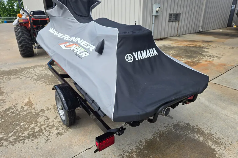 Slide: The Image of 2019 Yamaha WaveRunner VXR covered on trailer, parked near a building. - 9