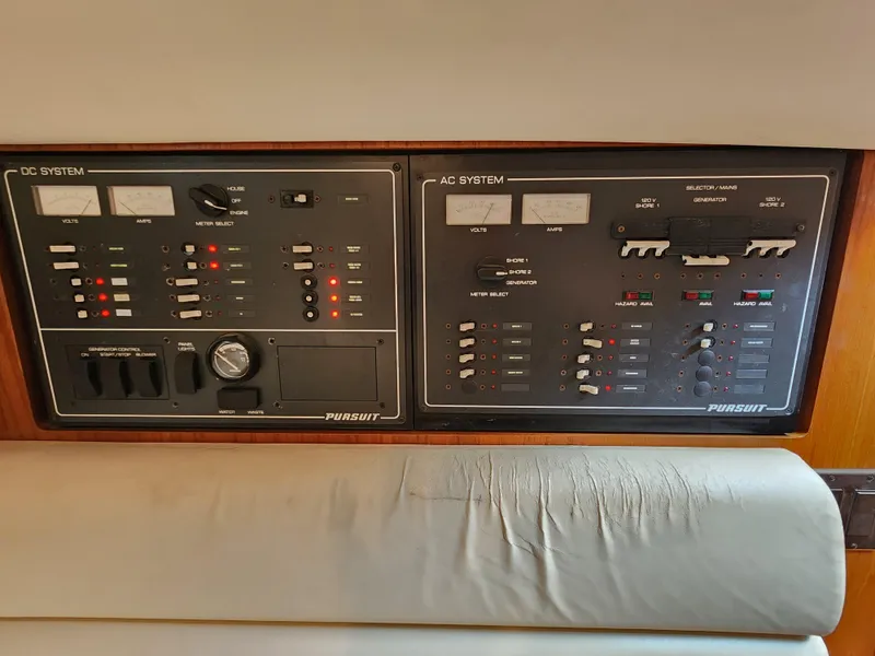 Slide: The Image of Pursuit 3400 Express 2000 model DC and AC system control panels. - 16