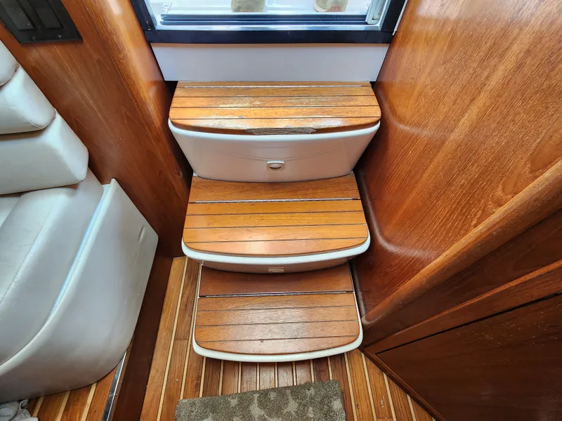 Slide: The Image of Wooden steps inside 2000 Pursuit 3400 Express boat cabin. - 17