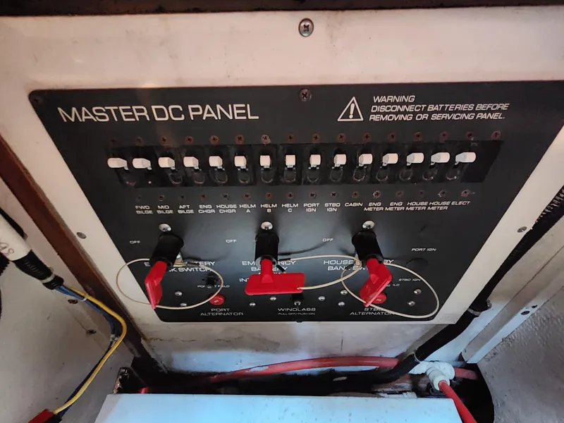 Slide: The Image of Master DC panel of a 2000 Pursuit 3400 Express boat with switches and warning label. - 18