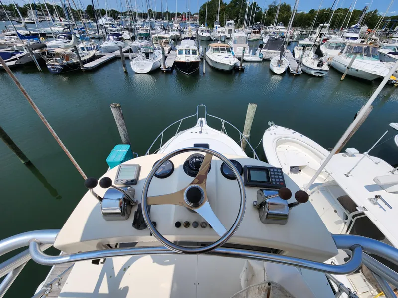 Slide: The Image of View from the helm of a 2000 Pursuit 3400 Express boat docked at a marina. - 20