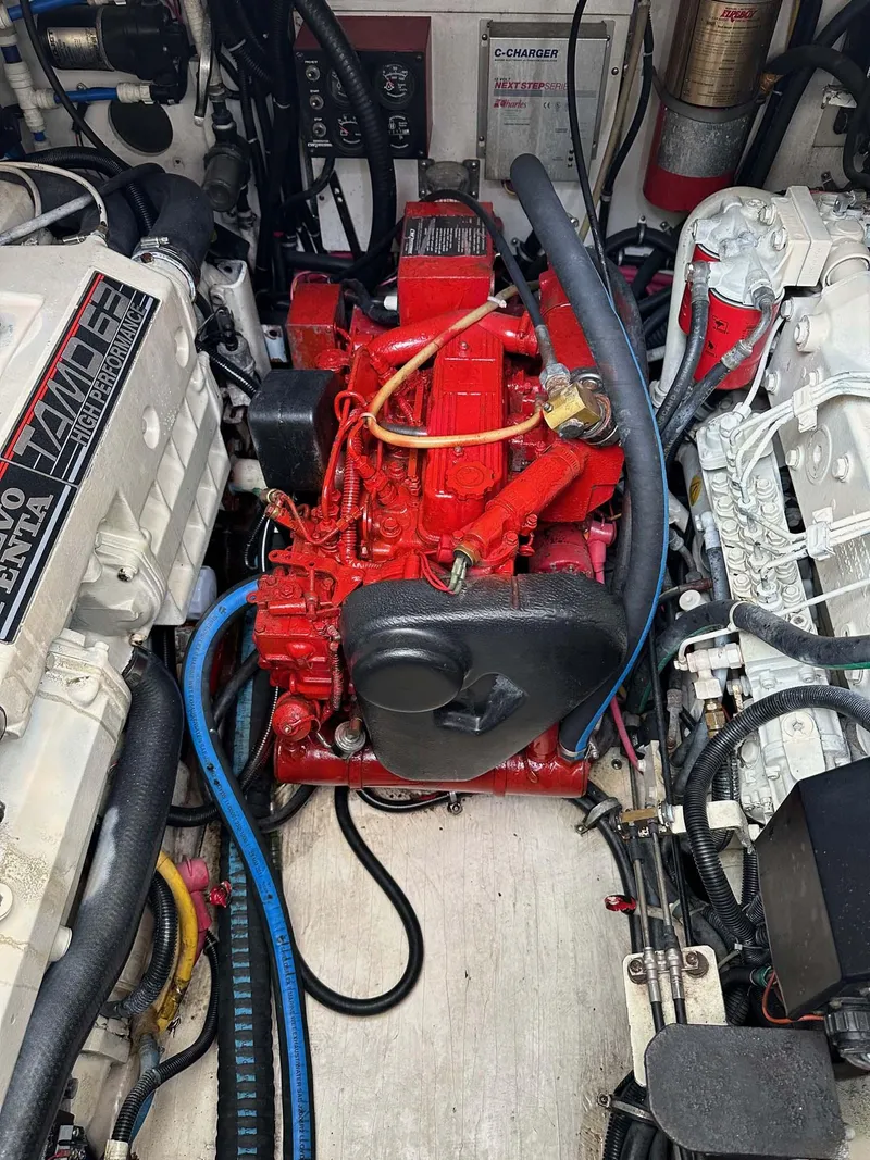 Slide: The Image of Engine compartment of a 2000 Pursuit 3400 Express boat with red and white components. - 23