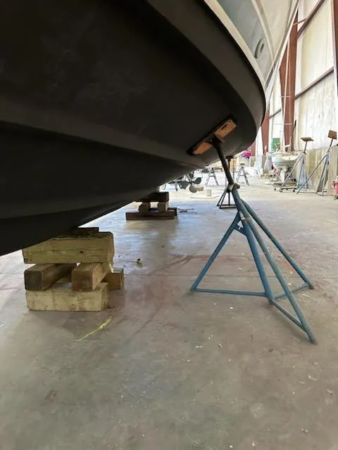 Slide: The Image of 2000 Pursuit 3400 Express boat on stands in a workshop. - 27