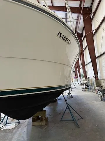 Slide: The Image of 2000 Pursuit 3400 Express boat named Isabella in storage facility. - 29