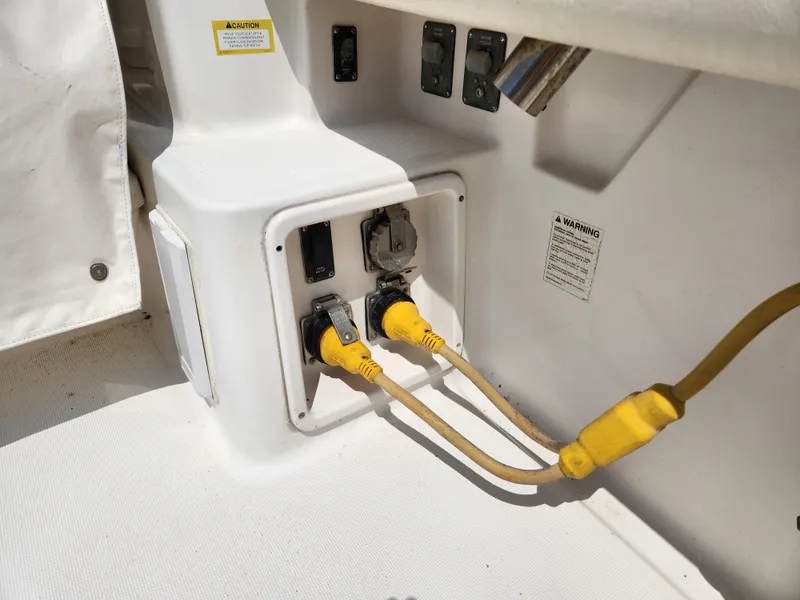 Slide: The Image of Electrical panel with yellow power cords on a 2000 Pursuit 3400 Express boat. - 5