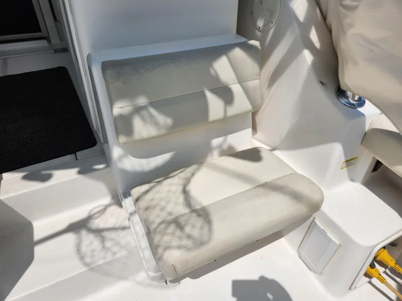 Slide: The Image of 2000 Pursuit 3400 Express boat seating area in sunlight. - 6