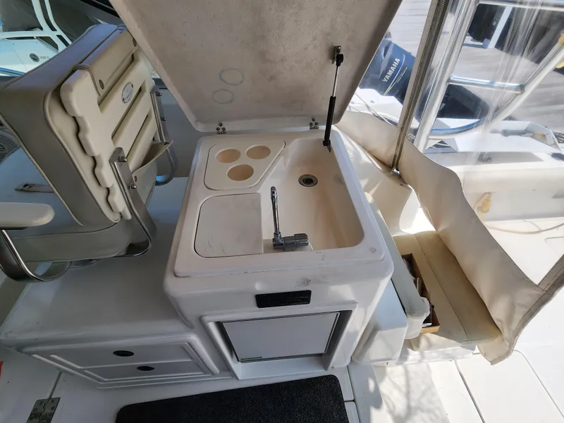 Slide: The Image of Pursuit 3400 Express 2000 boat interior with sink and storage compartments. - 7