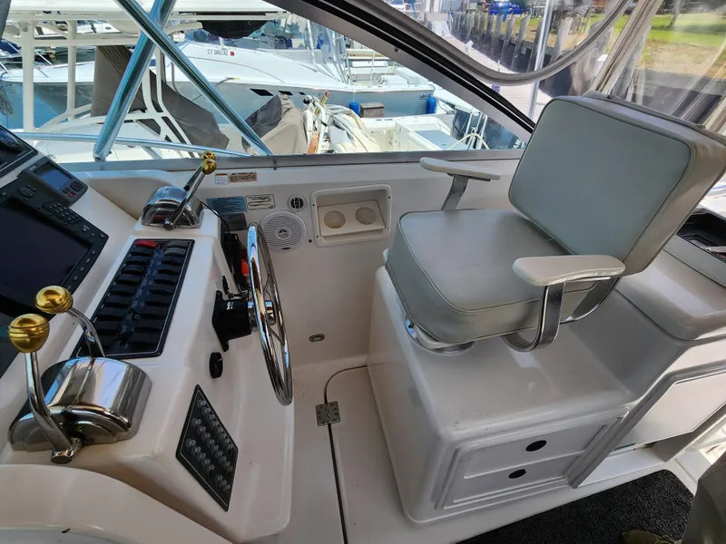 Slide: The Image of Helm station of a 2000 Pursuit 3400 Express boat with captain's chair and control panel. - 9