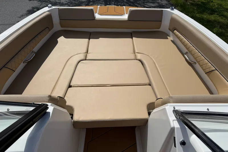 Slide: The Image of 2026 Bayliner D22I boat interior with beige cushioned seating and sleek design. - 5