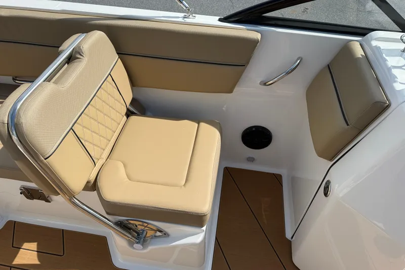 Slide: The Image of 2026 Bayliner D22I boat interior with beige cushioned seating and sleek design. - 8
