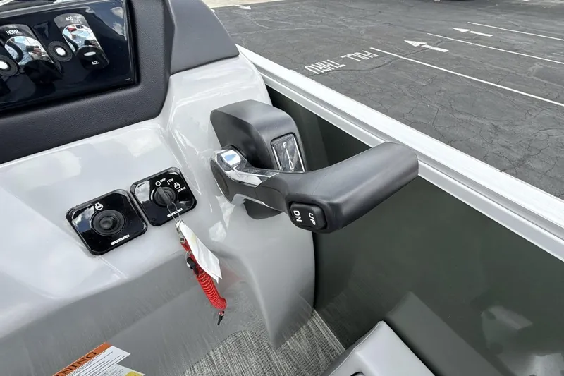 Slide: The Image of Control panel of 2026 Landau Alure boat with throttle and ignition switches. - 16