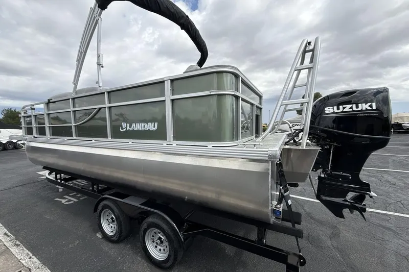 Slide: The Image of 2026 Landau Alure pontoon boat with Suzuki outboard motor on trailer. - 3