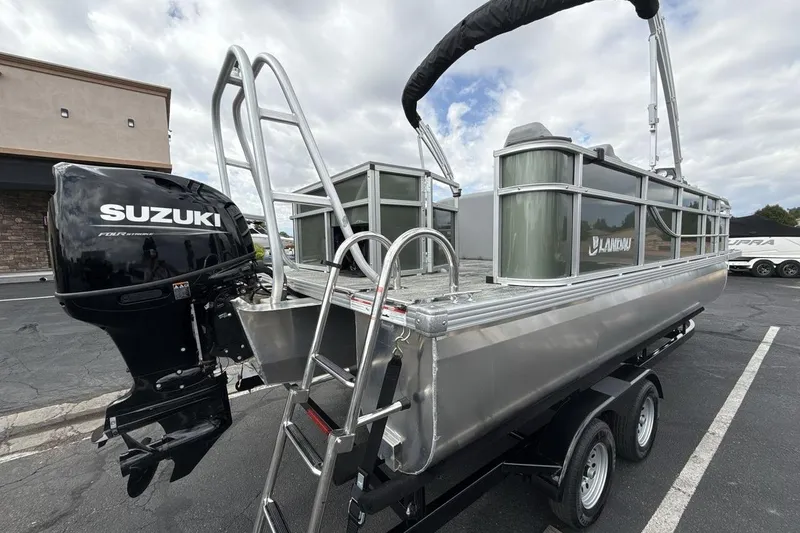 Slide: The Image of 2026 Landau Alure pontoon boat with Suzuki outboard motor on a trailer. - 5