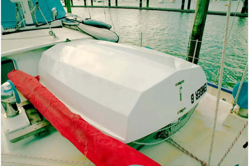 Slide: The Image of 1997 Crealock custom-built raised cabintop schooner docked, featuring a white deck and red cover. - 16