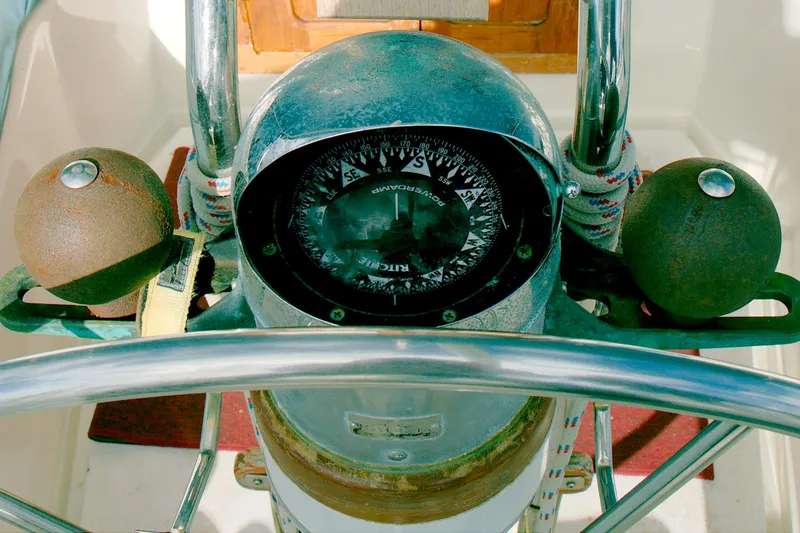 Slide: The Image of Compass and helm of a 1997 Crealock custom-built raised cabintop schooner. - 17
