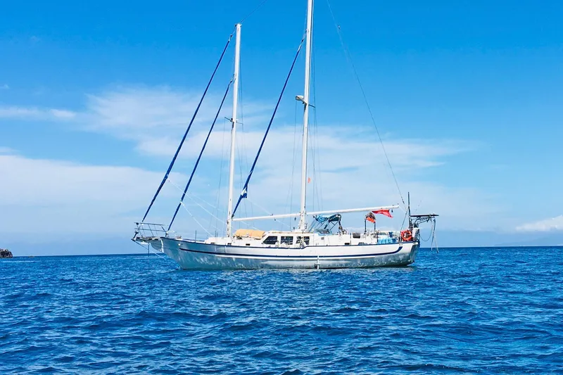Slide: The Image of Crealock 1997 custom-built raised cabintop schooner sailing on open blue sea. - 2