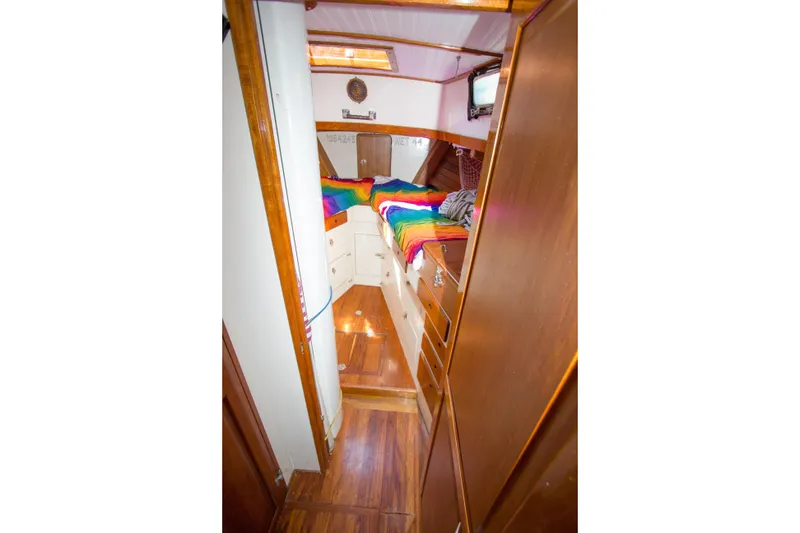 Slide: The Image of Interior of 1997 Crealock custom schooner with colorful bedding and wooden cabinetry. - 20