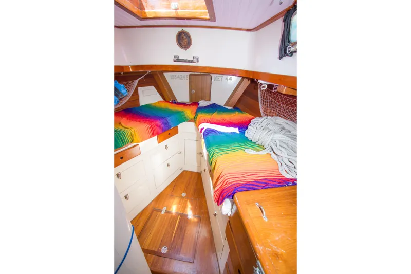 Slide: The Image of Interior of 1997 Crealock custom schooner with colorful bedding and wooden cabinetry. - 21