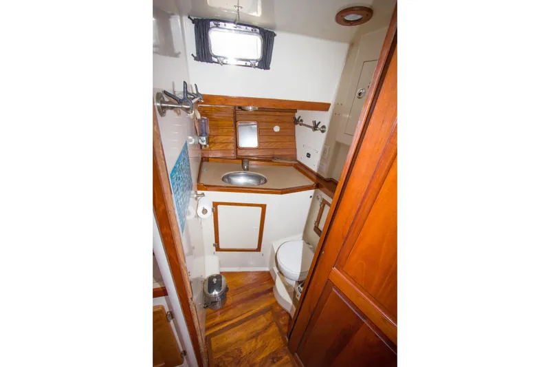 Slide: The Image of Bathroom interior of 1997 Crealock custom-built raised cabintop schooner, featuring wood accents and compact design. - 23