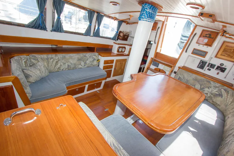 Slide: The Image of Cozy cabin interior of 1997 Crealock schooner with vibrant rainbow bedding and wooden accents. - 26