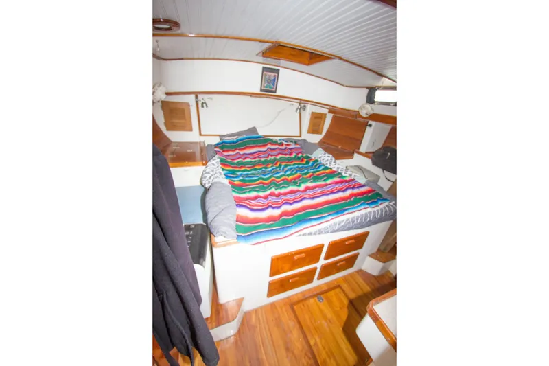 Slide: The Image of Cozy cabin interior of 1997 Crealock custom schooner with colorful bedding and wood accents. - 27