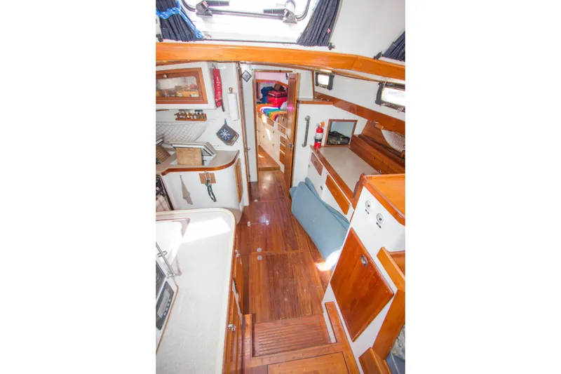 Slide: The Image of 1997 Crealock custom-built raised cabintop schooner docked, featuring a white deck and red cover. - 36