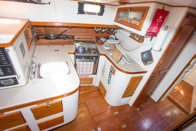Slide: The Image of Compass and helm of a 1997 Crealock custom-built raised cabintop schooner. - 37