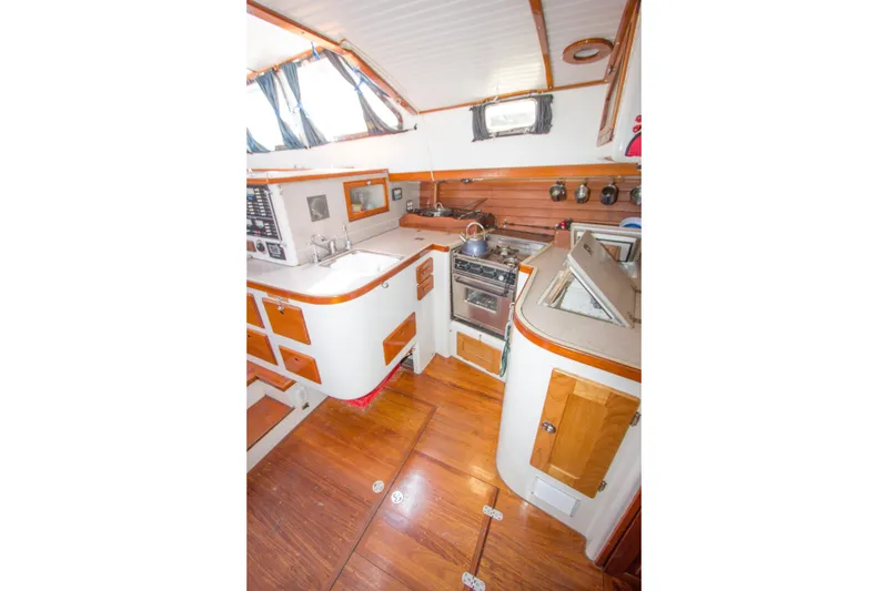 Slide: The Image of Storage area inside 1997 Crealock custom schooner with organized blue crates and equipment. - 38