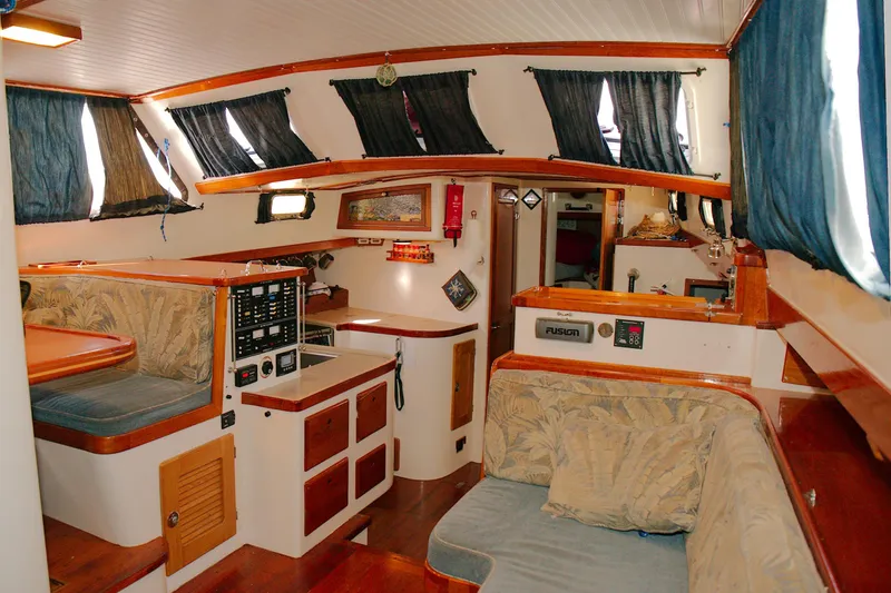 Slide: The Image of Interior of a 1997 Crealock custom-built raised cabintop schooner with cozy seating and nautical decor. - 4