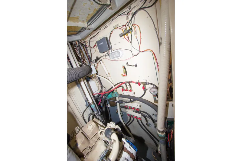 Slide: The Image of Engine room of 1997 Crealock custom-built schooner with wiring and mechanical components. - 42