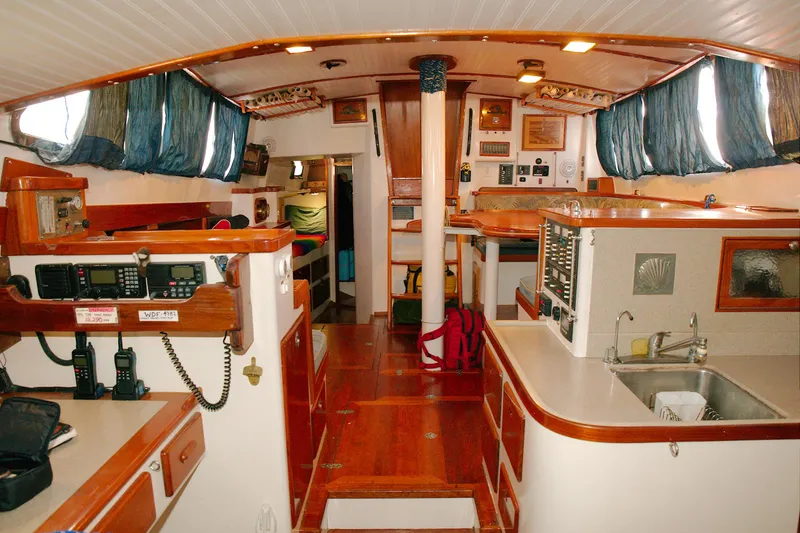 Slide: The Image of Interior of a 1997 Crealock custom-built raised cabintop schooner, featuring wood finishes and nautical equipment. - 5