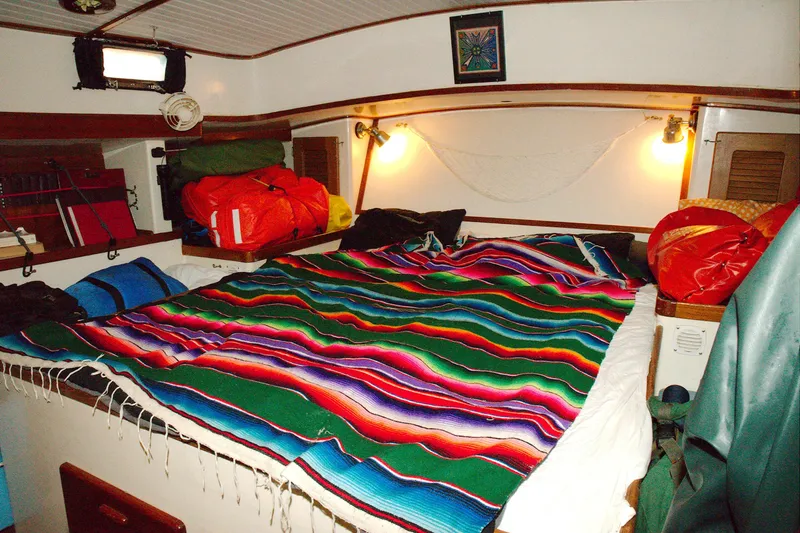 Slide: The Image of Cozy cabin interior of 1997 Crealock custom schooner with colorful bedding and warm lighting. - 8