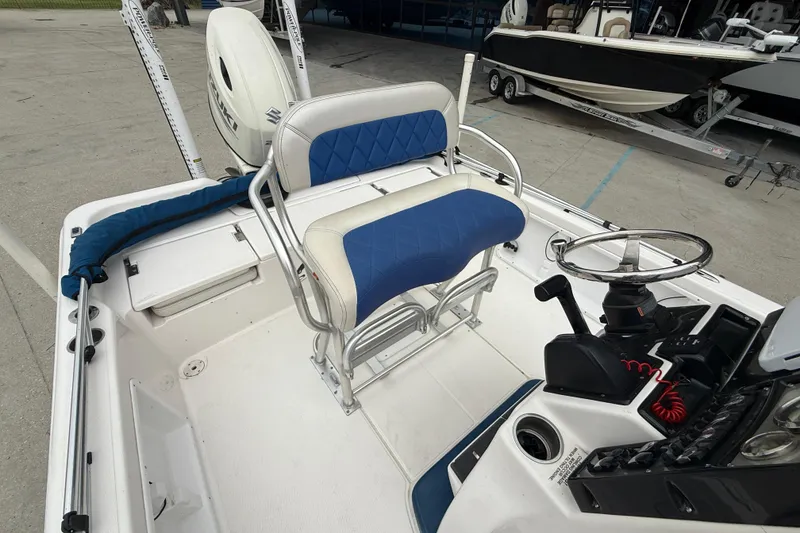 Slide: The Image of 2019 Blue Wave 2200 PureBay boat interior with steering console and seating. - 11