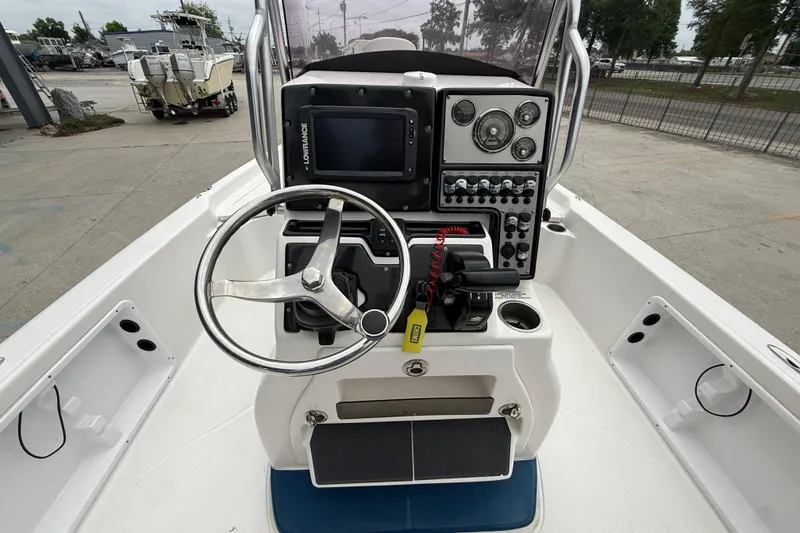 Slide: The Image of 2019 Blue Wave 2200 PureBay boat console with steering wheel and navigation controls. - 13