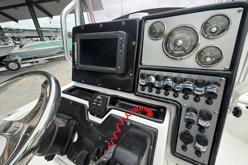 Slide: The Image of Control panel of a 2019 Blue Wave 2200 PureBay boat with gauges and switches. - 14