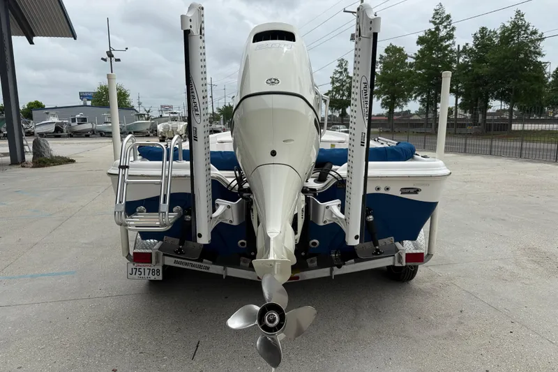 Slide: The Image of 2019 Blue Wave 2200 PureBay boat with outboard motor, parked on a trailer. - 5