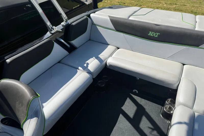 Slide: The Image of Interior seating of a 2016 MasterCraft NXT22 boat with gray upholstery. - 11
