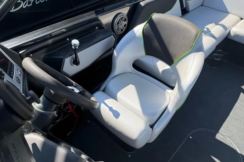Slide: The Image of 2016 MasterCraft NXT22 boat interior with steering wheel and seating. - 12
